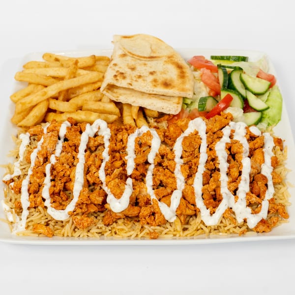 Ahsan's Halal chicken over rice with white sauce, fries, pita bread, and a side salad.
